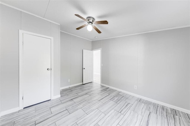 spare room featuring ornamental molding and ceiling fan