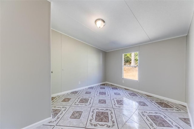 tiled spare room with crown molding