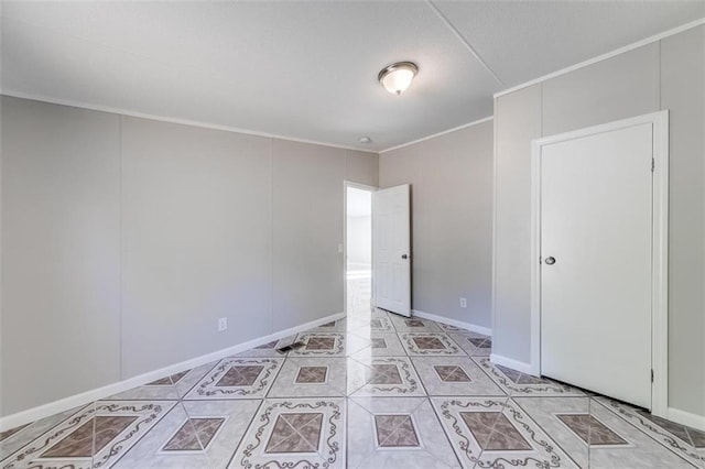 tiled spare room with ornamental molding