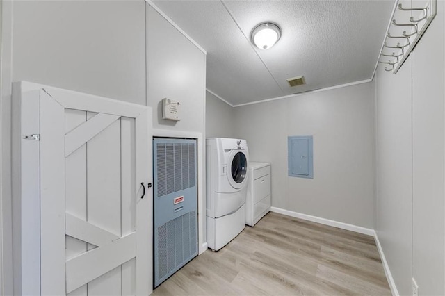 washroom featuring electric panel, a textured ceiling, separate washer and dryer, light hardwood / wood-style floors, and crown molding