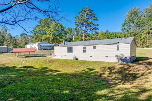 rear view of house featuring a yard