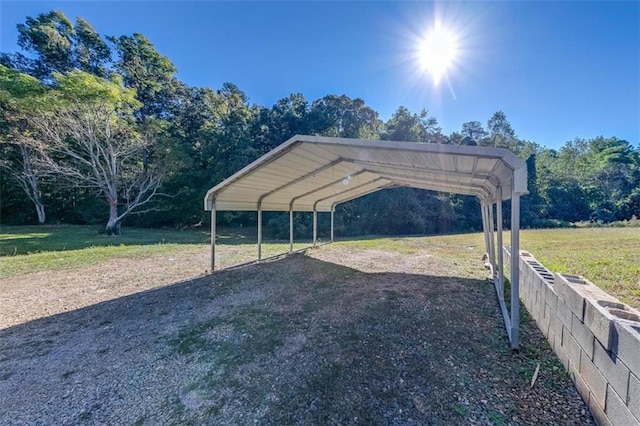 view of car parking with a yard and a carport