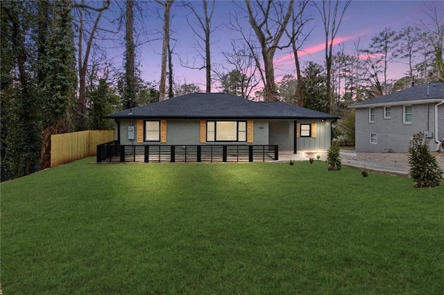 back house at dusk with a yard