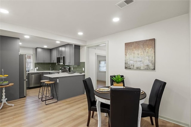 dining space featuring light hardwood / wood-style floors