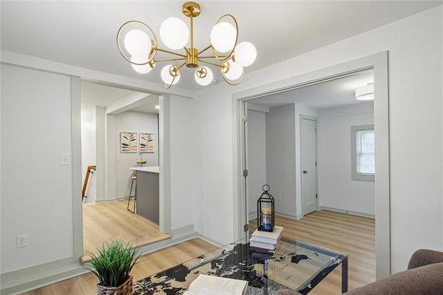 dining space with an inviting chandelier and light hardwood / wood-style flooring