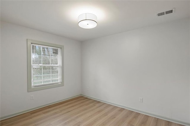 spare room featuring light hardwood / wood-style floors