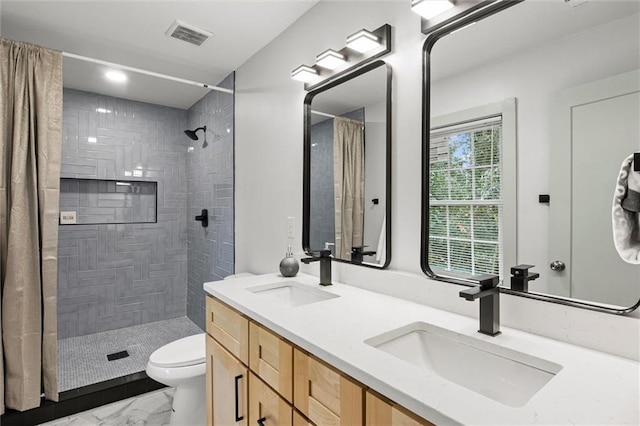 bathroom featuring vanity, toilet, and a shower with shower curtain