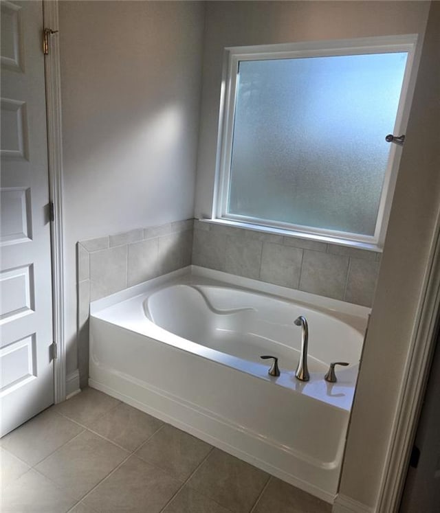 bathroom featuring tile patterned flooring and a bath