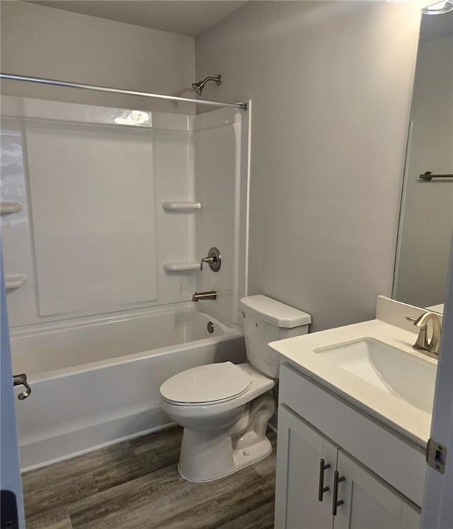 full bath featuring shower / bathtub combination, vanity, wood finished floors, and toilet