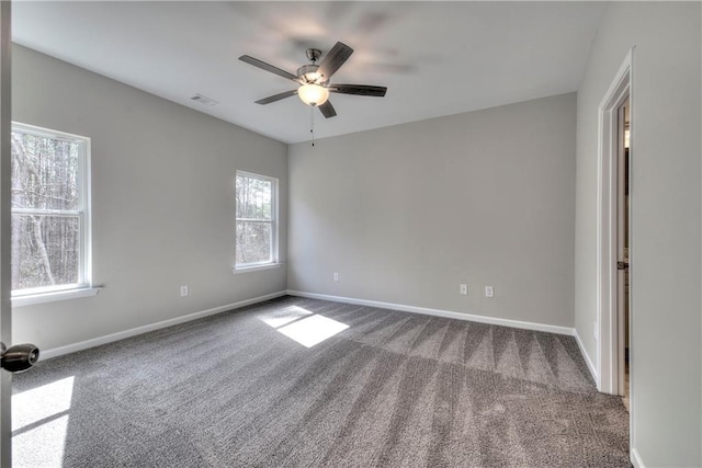 empty room with ceiling fan and carpet floors