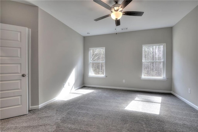 carpeted empty room featuring ceiling fan and a healthy amount of sunlight