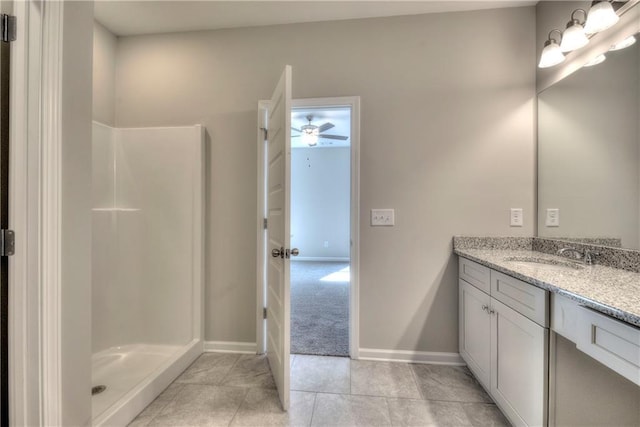 bathroom with tile patterned floors, a shower, and vanity