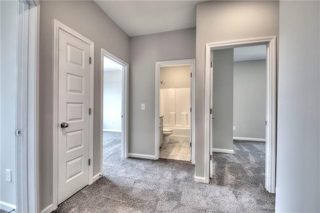 corridor with dark colored carpet