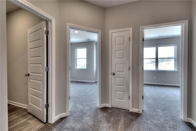 hall with light colored carpet