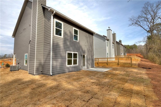 rear view of property featuring a patio area and cooling unit