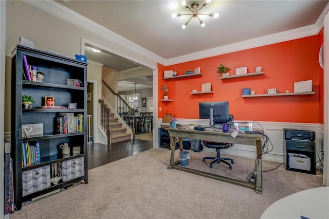 office space featuring a notable chandelier, crown molding, carpet flooring, and wainscoting