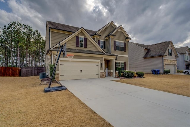 craftsman inspired home featuring central air condition unit, a garage, brick siding, fence, and driveway