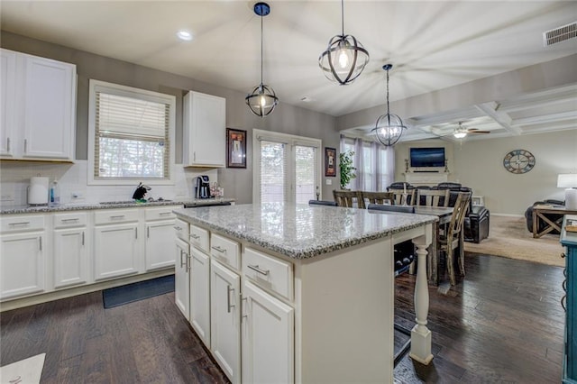 kitchen with visible vents, coffered ceiling, dark wood-style floors, open floor plan, and backsplash