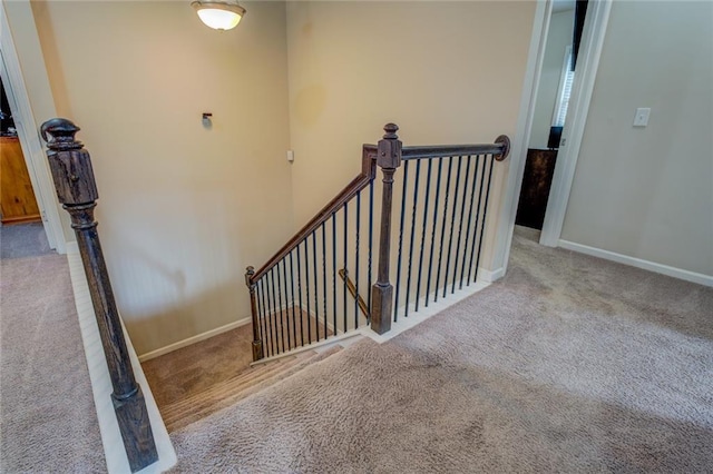 stairs featuring carpet floors and baseboards