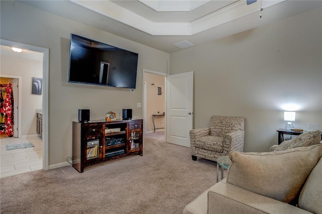 living room with carpet floors, a raised ceiling, and baseboards