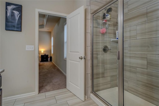 full bath featuring a stall shower and baseboards