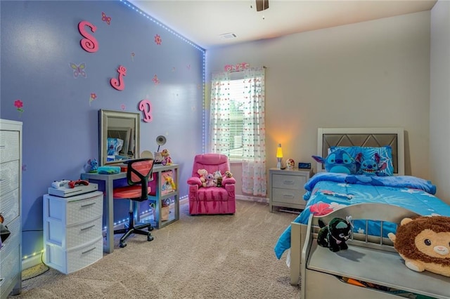 carpeted bedroom featuring ceiling fan and visible vents