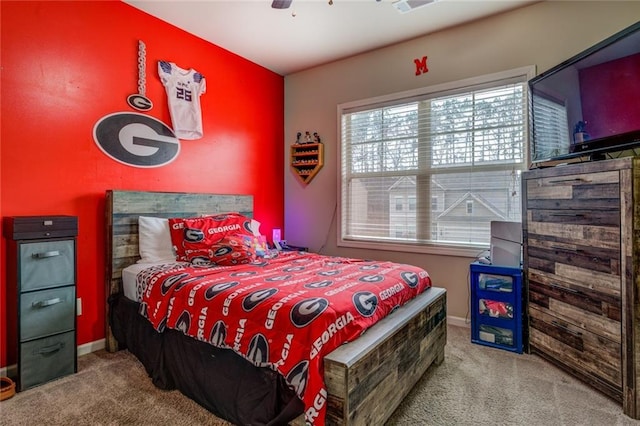 carpeted bedroom with ceiling fan and baseboards