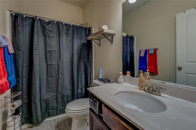 bathroom with toilet, vanity, and a shower with curtain