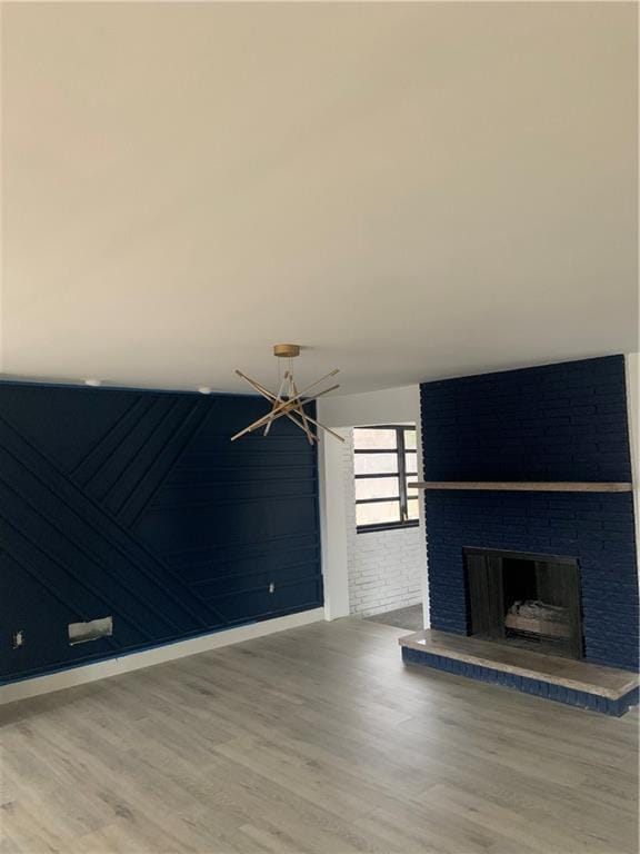 unfurnished living room with hardwood / wood-style flooring and a fireplace