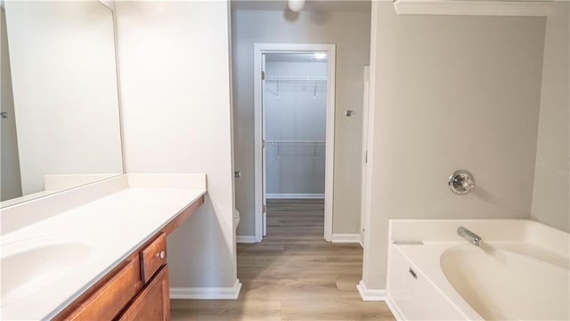 3176 Creston Park Ct, Duluth, GA 30096 - bathroom featuring a bath, vanity, wood finished floors, and a spacious closet