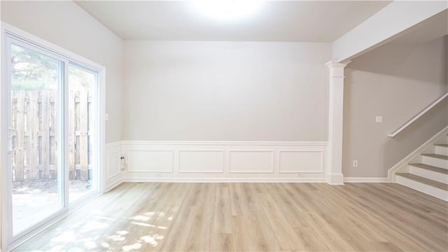 3176 Creston Park Ct, Duluth, GA 30096 - empty room featuring light wood-type flooring, stairway, decorative columns, and wainscoting