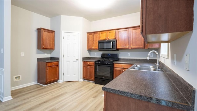3176 Creston Park Ct, Duluth, GA 30096 - kitchen featuring black gas range, light wood-type flooring, dark countertops, and brown cabinetry