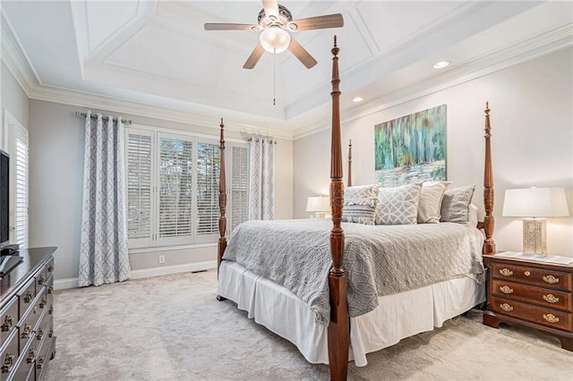 carpeted bedroom featuring a tray ceiling, ornamental molding, and ceiling fan