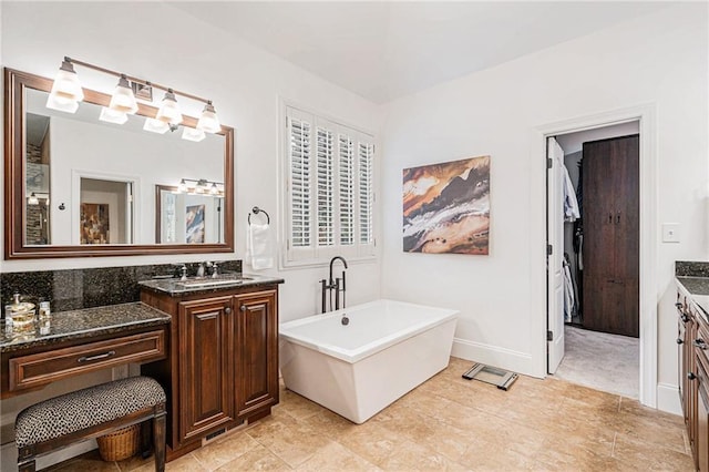 bathroom featuring vanity and a bath