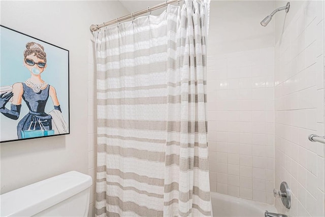 bathroom with shower / bath combination with curtain and toilet