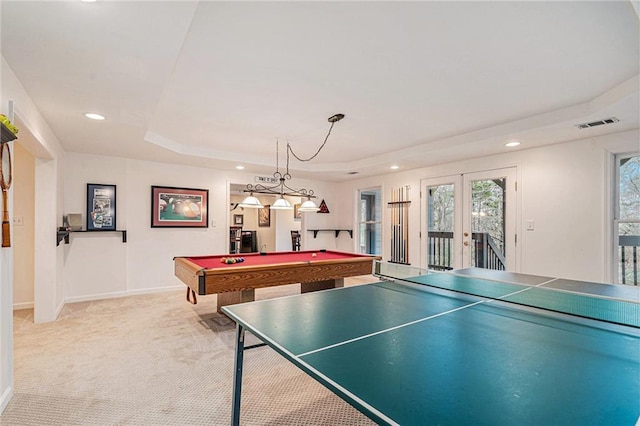 game room with french doors, light carpet, pool table, and a tray ceiling