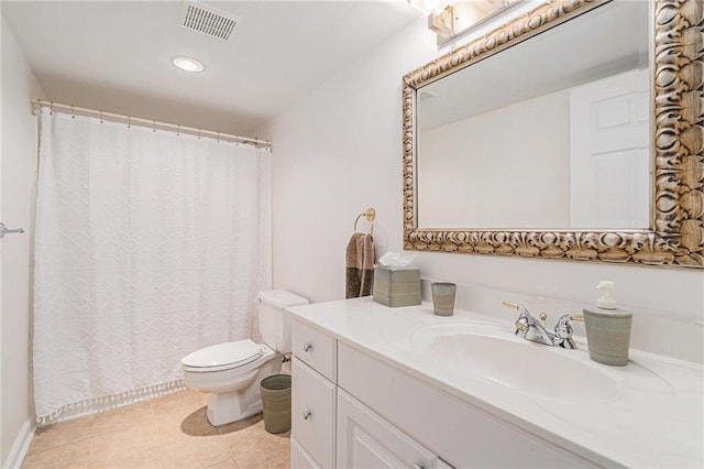 bathroom featuring vanity, tile patterned floors, and toilet