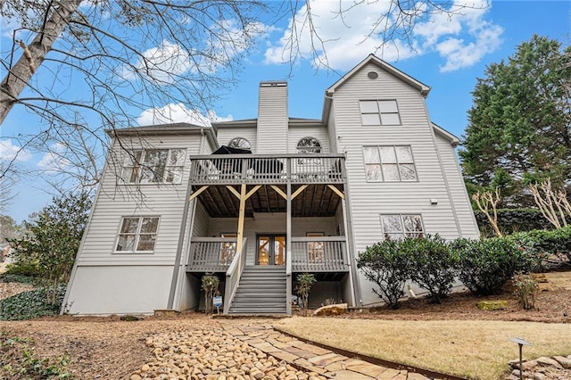 rear view of property featuring a wooden deck