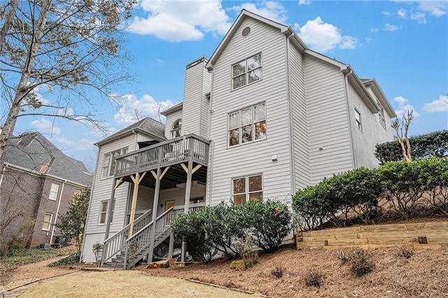 back of property featuring a wooden deck