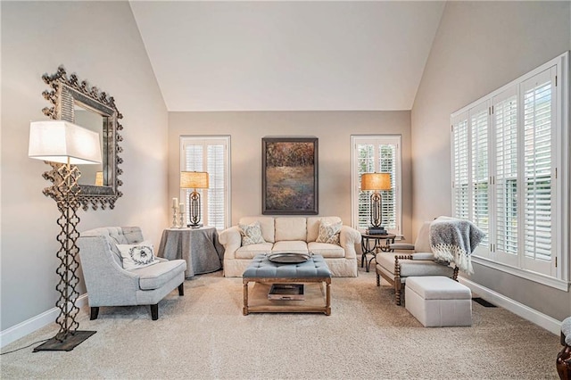 carpeted living room featuring lofted ceiling