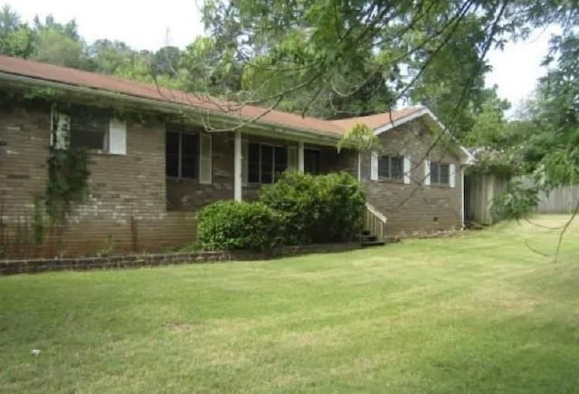 view of side of home featuring a yard