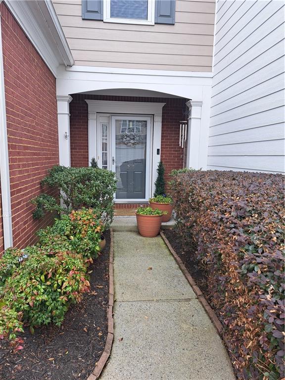 view of exterior entry with brick siding