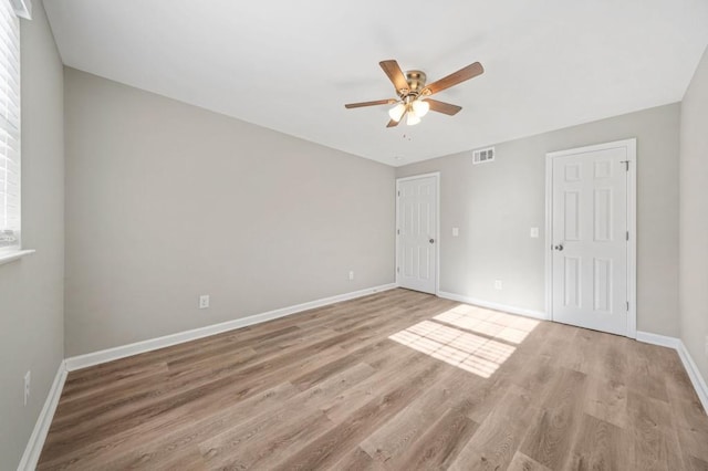 spare room with light hardwood / wood-style floors and ceiling fan