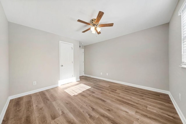 empty room with ceiling fan and wood-type flooring