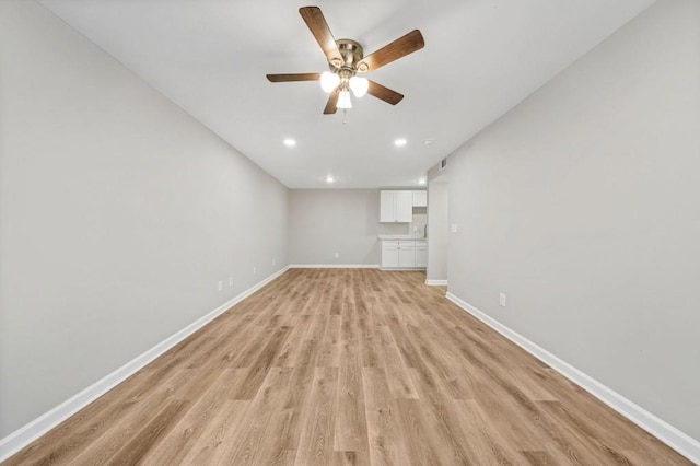 unfurnished living room with light hardwood / wood-style flooring and ceiling fan