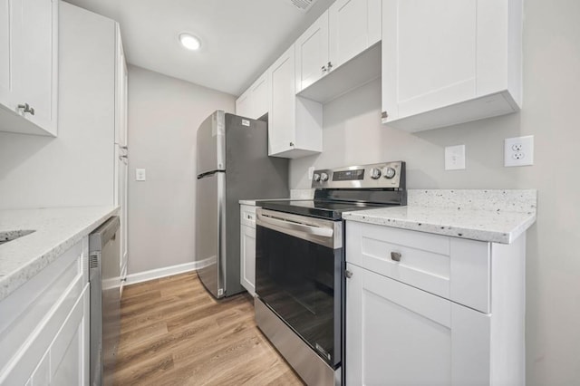 kitchen featuring white cabinetry, appliances with stainless steel finishes, light stone countertops, and light hardwood / wood-style floors