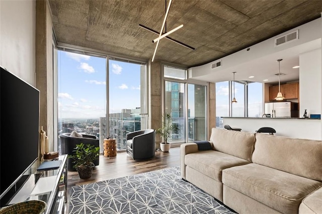 living area with a wall of windows, visible vents, a ceiling fan, and dark wood-style flooring