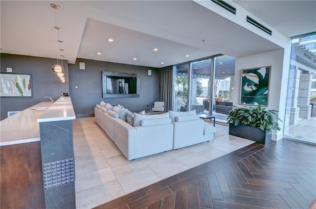 living area with recessed lighting, baseboards, and a wall of windows