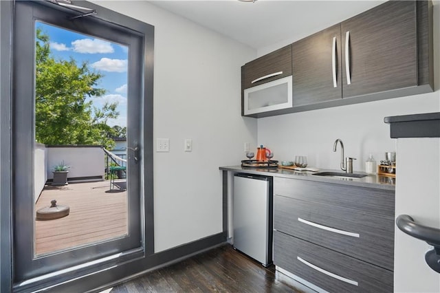 1300 Dekalb Ave NE Unit 731, Atlanta, GA 30307 - indoor wet bar with freestanding refrigerator and dark wood-style flooring