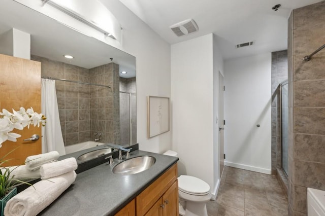 bathroom with toilet, tile patterned flooring, and vanity